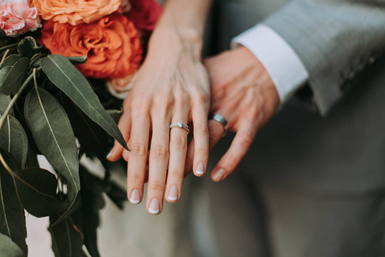 Man and woman wearing engagement rings - Photo Credit: Samantha Gades/Unsplash